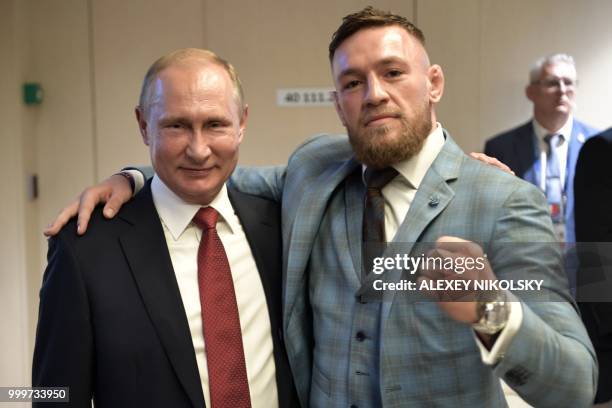 Russian President Vladimir Putin and Irish Mixed Martial Arts fighter Conor McGregor pose after the first half of the Russia 2018 World Cup final...