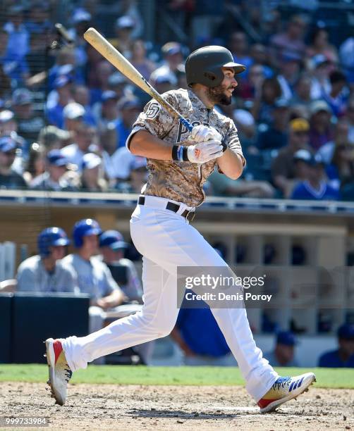 Eric Hosmer of the San Diego Padres hits a single during the sixth inning of a baseball game against the Chicago Cubs at PETCO Park on July 15, 2018...