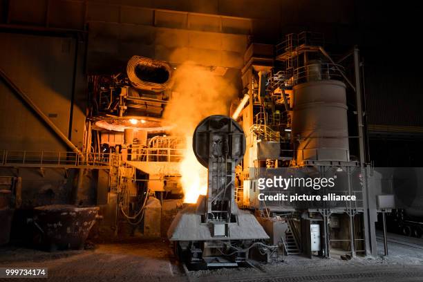Molten steel is poured out of an electric arc furnace in the ArcelorMittal factory in Hamburg, Germany, 14 July 2017. The company, the world's...