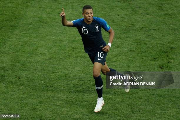 France's forward Kylian Mbappe celebrates after scoring a goal during the Russia 2018 World Cup final football match between France and Croatia at...