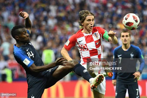 Croatia's midfielder Luka Modric vies with France's midfielder Blaise Matuidi during the Russia 2018 World Cup final football match between France...