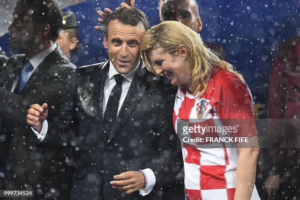 French President Emmanuel Macron talks with Croatian President Kolinda Grabar-Kitarovic during the trophy ceremony at the end of the Russia 2018...