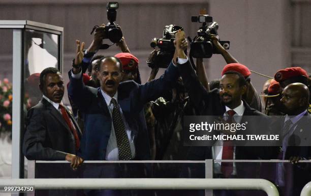 President Isaias Afwerki of Eritrea and Prime Minister Abiy Ahmed of Ethiopia salute the people gathered at the millennium hole to hear speech from...