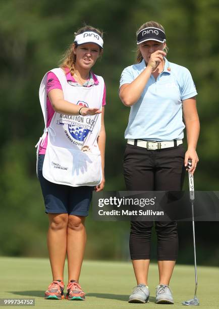Brooke Henderson of Canada talks with her caddie, Brittany Henderson, on the 18th hole during the final round of the Marathon Classic Presented By...