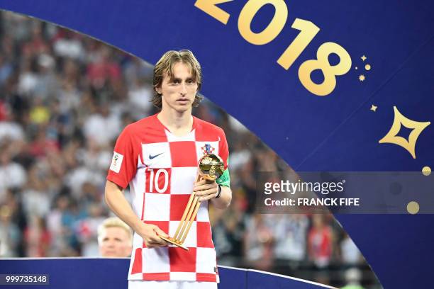 Croatia's midfielder Luka Modric holds the adidas Golden Ball prize during the trophy ceremony at the end of the Russia 2018 World Cup final football...