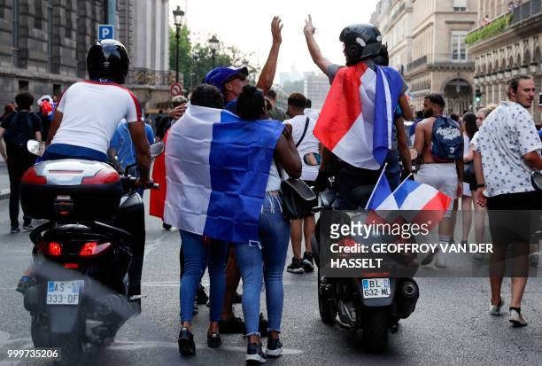 Woman celebrates in Rue Royale in Paris on July 15 after France won the Russia 2018 World Cup final football match between France and Croatia.