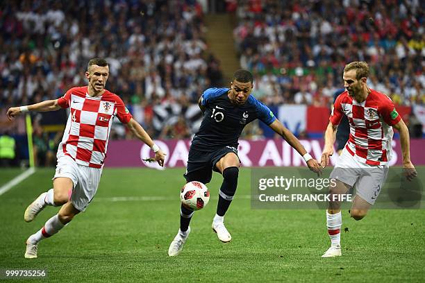France's forward Kylian Mbappe vies with Croatia's defender Ivan Strinic and Croatia's forward Ivan Perisic during the Russia 2018 World Cup final...
