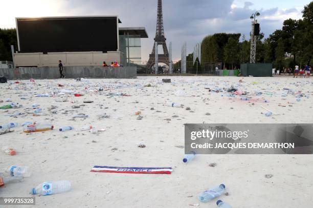 The garbage left by fans in the fan zone is pictured after the Russia 2018 World Cup final football match between France and Croatia, on the Champ de...