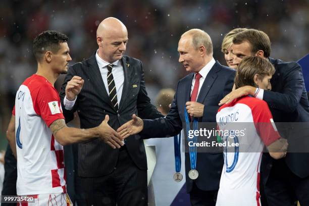 President of Russia Vladimir Putin presents Dejan Lovren and Luka Modric of Croatia with their medals next to FIFA president Gianni Infantino and...