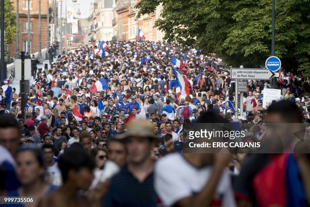 People celebrate France's victory in the Russia 2018 World Cup final football match between France and Croatia, on July 15, 2018 in Toulouse's city...
