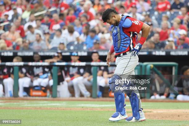 Keibert Ruiz of the Los Angeles Dodgers and the World Team leaves the game injured in the seventh inning against the U.S. Team during the SiriusXM...