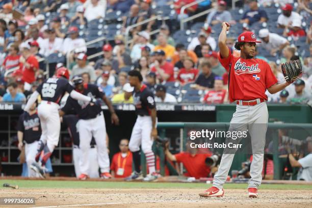 Adonis Medina of the World Team looks on after a wild pitch that allowed a run in the seventh inning against the U.S. Team during the SiriusXM...