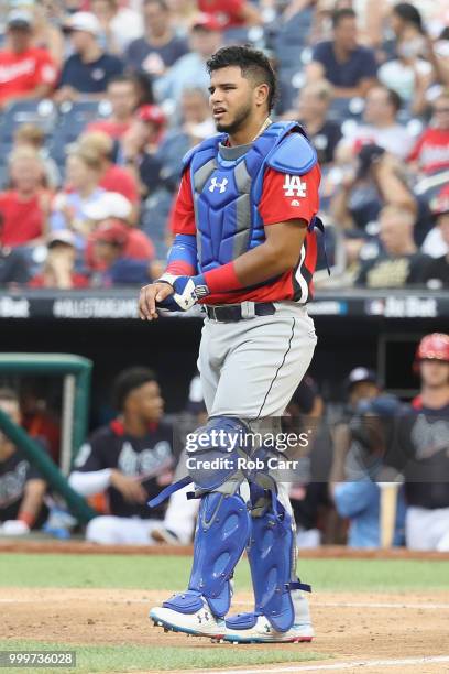 Keibert Ruiz of the Los Angeles Dodgers and the World Team leaves the game injured in the seventh inning against the U.S. Team during the SiriusXM...