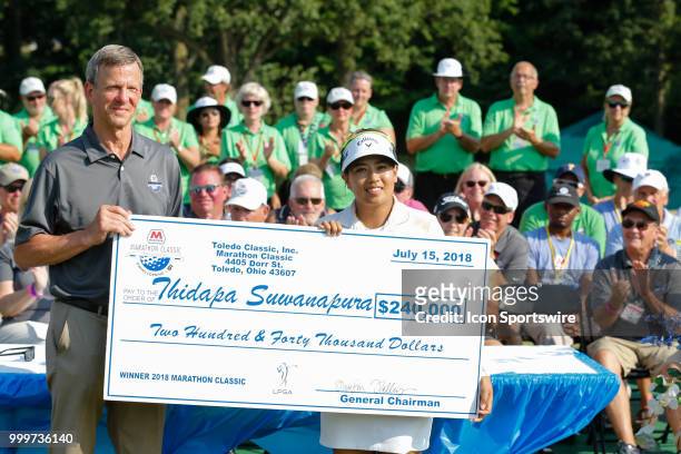Thidapa Suwannapura, of Thailand, accepts the winner's check during the awards ceremony following the final round of the LPGA Marathon Classic...