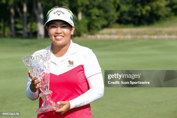 Thidapa Suwannapura, of Thailand, poses for photographs with the winner's trophy following the awards ceremony during the final round of the LPGA...