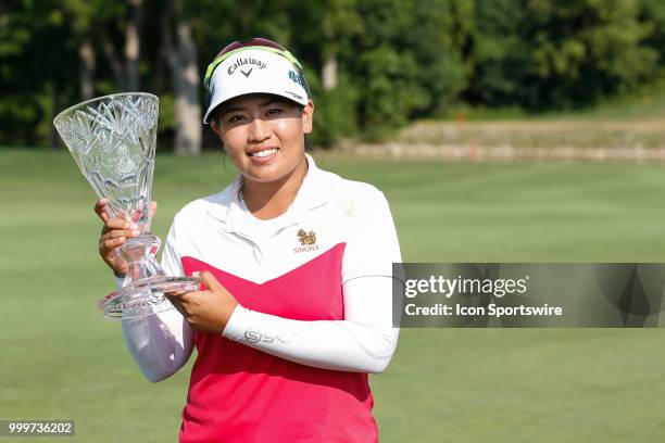 Thidapa Suwannapura, of Thailand, poses for photographs with the winner's trophy following the awards ceremony during the final round of the LPGA...