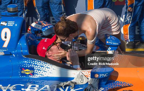 Scott Dixon, of New Zealand, gets a kiss from wife Emma Dixon in the Winner's Circle after takeing the checkered flag at Honda Indy Toronto race at...