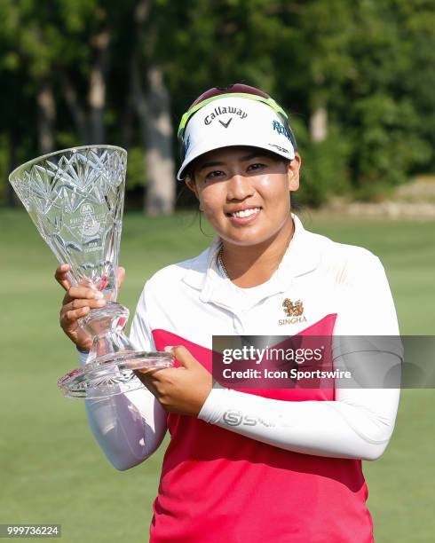 Thidapa Suwannapura, of Thailand, poses for photographs with the winner's trophy following the awards ceremony during the final round of the LPGA...