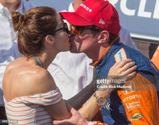 Scott Dixon, of New Zealand, gets a kiss from wife Emma Dixon in the Winners Circle. Dixon took the checkered flag at Honda Indy Toronto race at CNE...