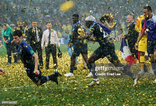 Benjamin Mendy holds up the trophy as he celebrates FIFA World Cup championship after the 2018 FIFA World Cup Russia Final between France and Croatia...