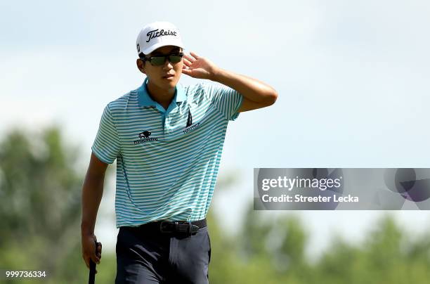 Michael Kim reacts after making a putt on the 16th green during the final round of the John Deere Classic at TPC Deere Run on July 15, 2018 in...