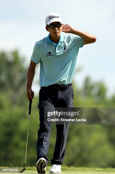 Michael Kim reacts after making a putt on the 16th green during the final round of the John Deere Classic at TPC Deere Run on July 15, 2018 in...