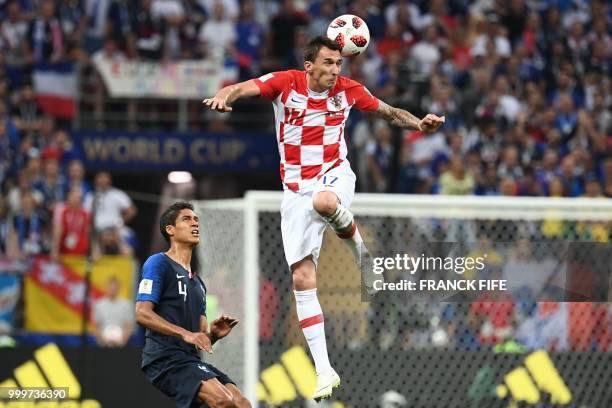 Croatia's forward Mario Mandzukic vies with France's defender Raphael Varane during the Russia 2018 World Cup final football match between France and...