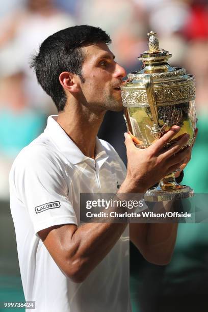 Mens Singles Final - Novak Djokovic v Kevin Anderson - Novak Djokovic kisses the trophy at All England Lawn Tennis and Croquet Club on July 15, 2018...