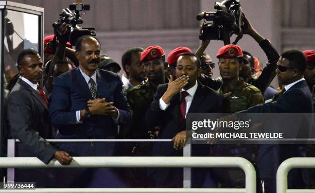 President Isaias Afwerki of Eritrea and Prime Minister Abiy Ahmed of Ethiopia salute the people gathered at the millennium hole to hear speech from...