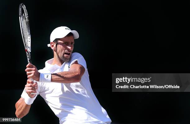 Mens Singles Final - Novak Djokovic v Kevin Anderson - The strings of the tennis racquet casts a shadow across the face of Novak Djokovic at All...