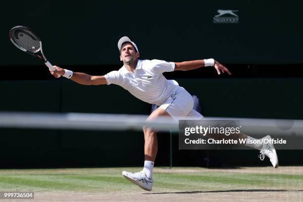 Mens Singles Final - Novak Djokovic v Kevin Anderson - Novak Djokovic at full stretch at All England Lawn Tennis and Croquet Club on July 15, 2018 in...