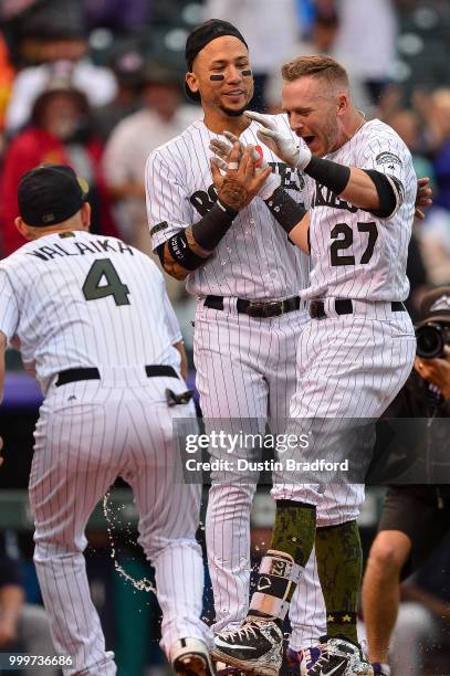 Trevor Story and Carlos Gonzalez of the Colorado Rockies celebrate a ninth-inning, walk-off home run by Story and a 4-3 win over the Seattle Mariners...
