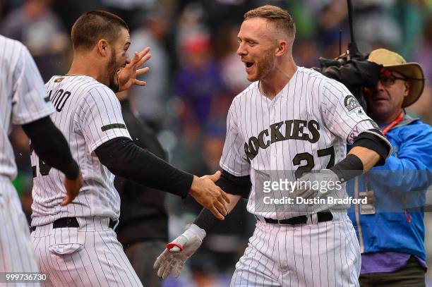 Trevor Story and Nolan Arenado of the Colorado Rockies celebrate a ninth-inning, walk-off home run by Story and a 4-3 win over the Seattle Mariners...