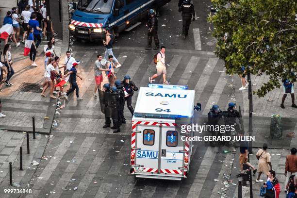 This picture taken from the terrace of the Publicis drugstore on July 15, 2018 shows French gendarmes and an emergency service Samu vehicle after...