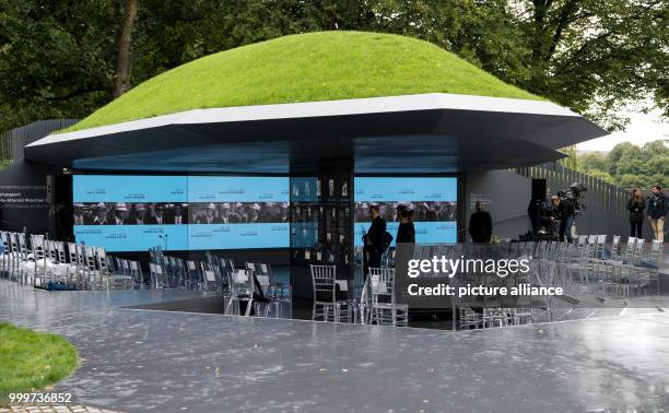 Visitors look at information displays at the newly unveiled memorial in honour of the victims of the 1972 Munich Summer Olympics massacre in Munich,...