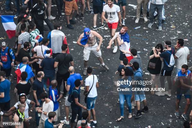 This picture taken from the terrace of the Publicis drugstore on July 15, 2018 shows people clashing after France won the Russia 2018 World Cup final...