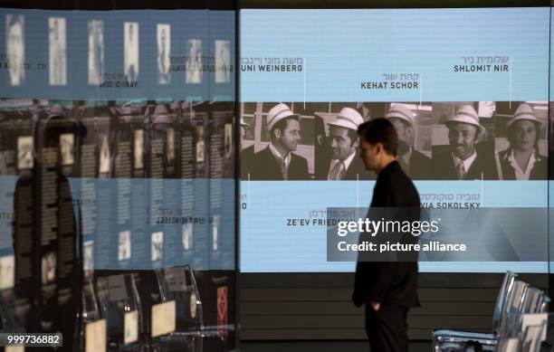 Man looks at information displays at the newly unveiled memorial in honour of the victims of the 1972 Munich Summer Olympics massacre in Munich,...