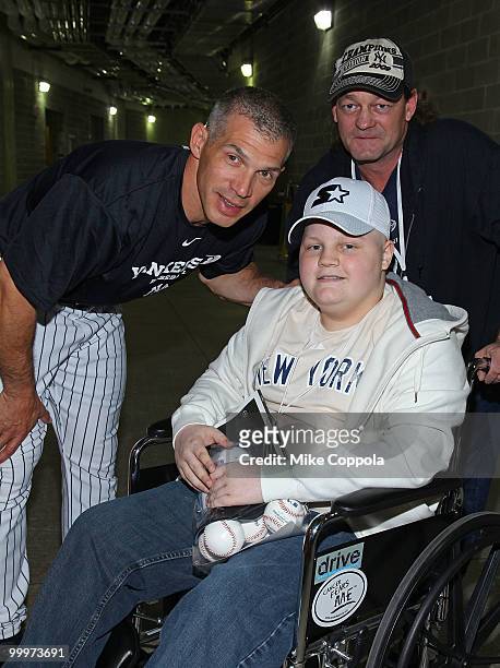New York Yankees Manager Joe Girardi, Jack Williams and Roger Williams pose for pictures at the starter event at NY Yankees batting practice at...