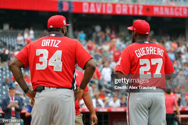 David Ortiz and Vladimir Guerrero of the World Team look on during player introductions prior to the SiriusXM All-Star Futures Game at Nationals Park...