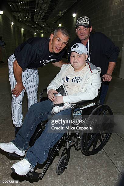 New York Yankees Manager Joe Girardi, Jack Williams and Roger Williams pose for pictures at the starter event at NY Yankees batting practice at...