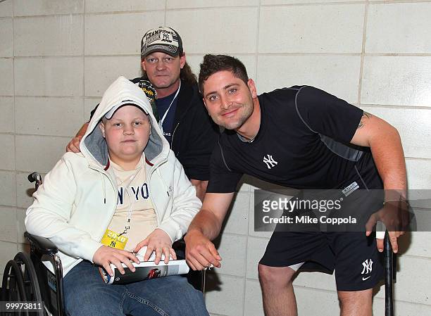 Jack Williams, Roger Williams, and New York Yankees catcher Francisco Cervelli pose for pictures at the starter event at NY Yankees batting practice...