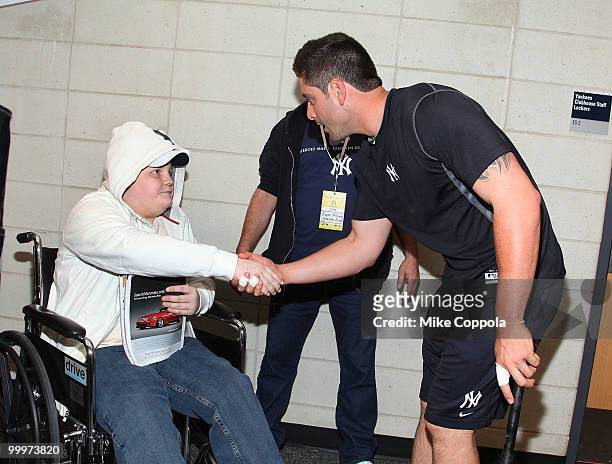 Jack Williams shake hands with New York Yankees catcher Francisco Cervelli at the starter event at NY Yankees batting practice at Yankee Stadium on...