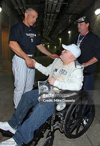 New York Yankees Manager Joe Girardi shakes hands with Jack Williams and Roger Williams at the starter event at NY Yankees batting practice at Yankee...