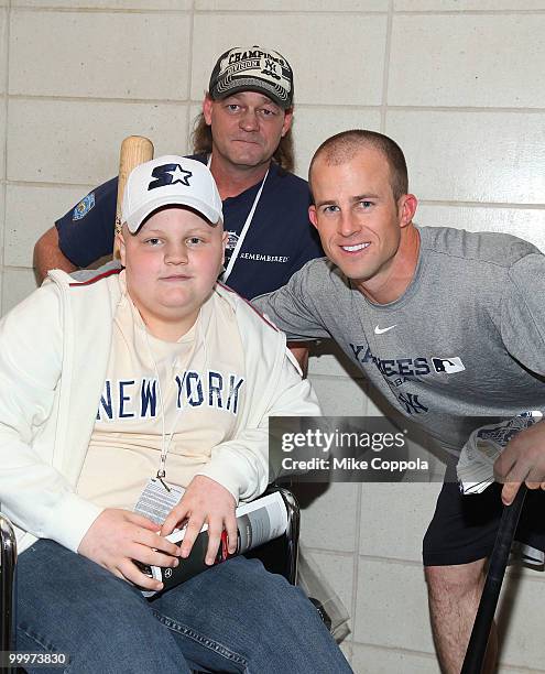 Jack Williams, Roger Williams, and New York Yankees outfielder Brett Gardner pose for pictures at the starter event at NY Yankees batting practice at...