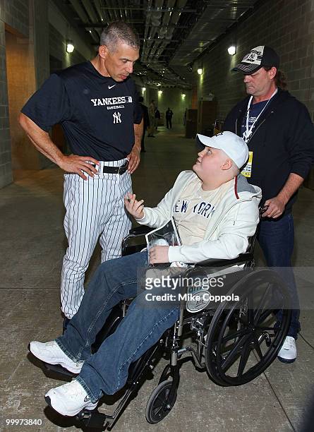 New York Yankees Manager Joe Girardi speaks with Jack Williams and Roger Williams at the starter event at NY Yankees batting practice at Yankee...