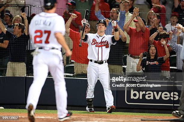 Nate McLouth of the Atlanta Braves celebrates as Brent Clevlen scores the game-winning run against the New York Mets at Turner Field on May 18, 2010...