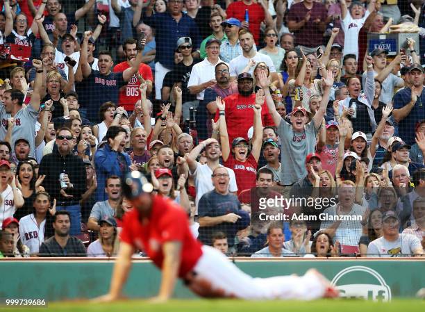 The fans react after Sam Travis of the Boston Red Sox slides safely past the tag of Russell Martin of the Toronto Blue Jays in the second inning of a...