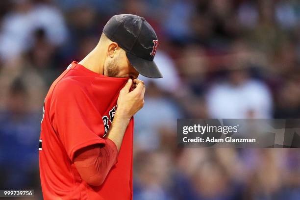 Rick Porcello of the Boston Red Sox reacts after giving up a two-run home run to Dwight Smith Jr. #27 of the Toronto Blue Jays in the third inning of...