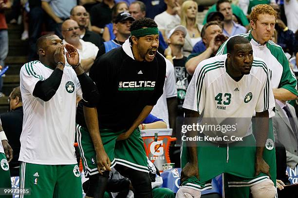 Nate Robinson, Rasheed Wallace and Kendrick Perkins of the Boston Celtics cheer on their teammates from the bench against the Orlando Magic in Game...