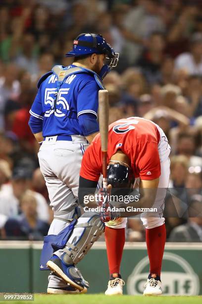 Russell Martin of the Toronto Blue Jays looks on as Mookie Betts of the Boston Red Sox reacts after striking out in the fifth inning of a game at...